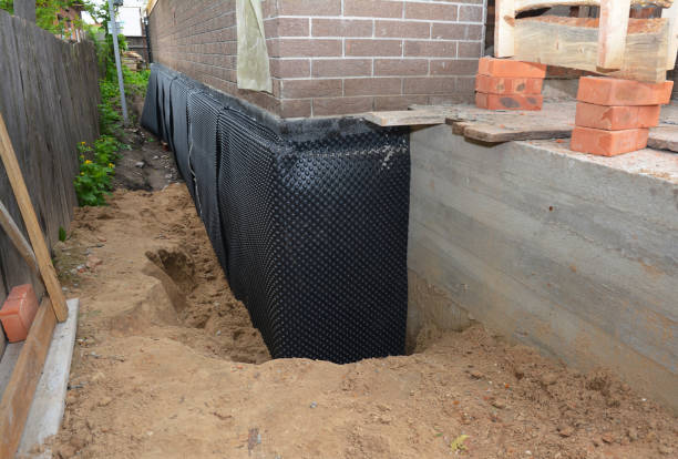 Happy homeowners after waterproofing job in Delevan